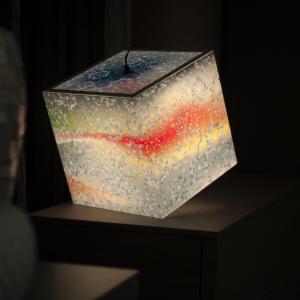 Winter time light cube ambient lamp shining light on a table
