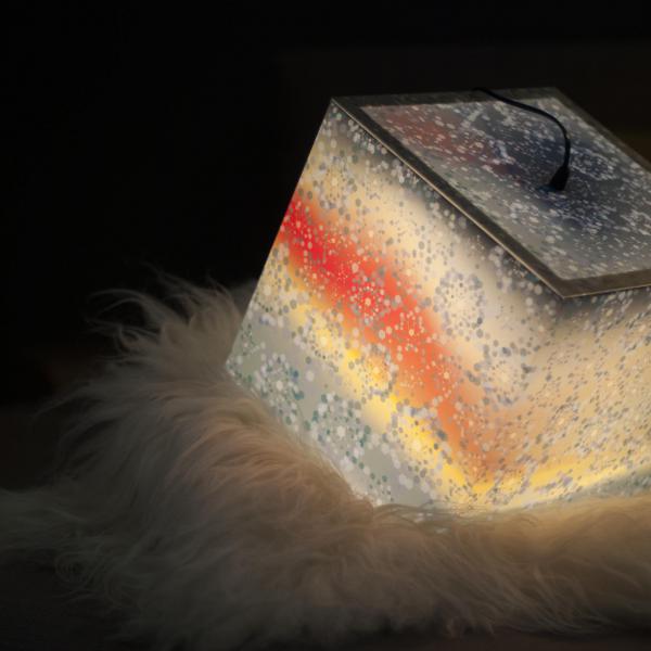 Beutiful ambient light cube lamp with a winter snowflake pattern used as a bedroom lighting