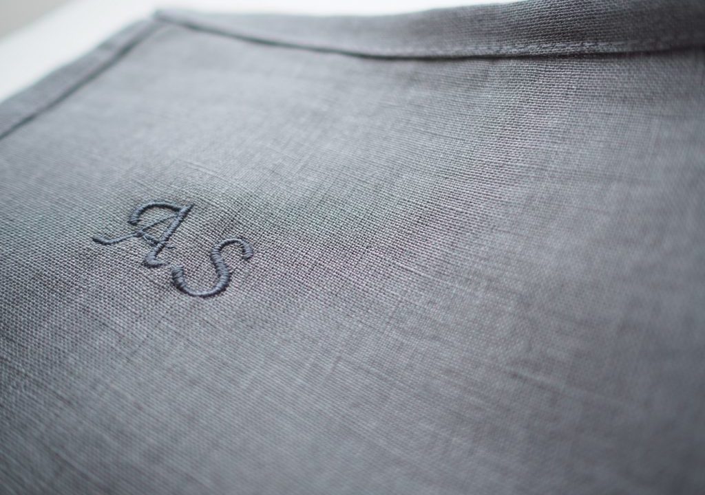 A personalized embroidery on blue linen fabric