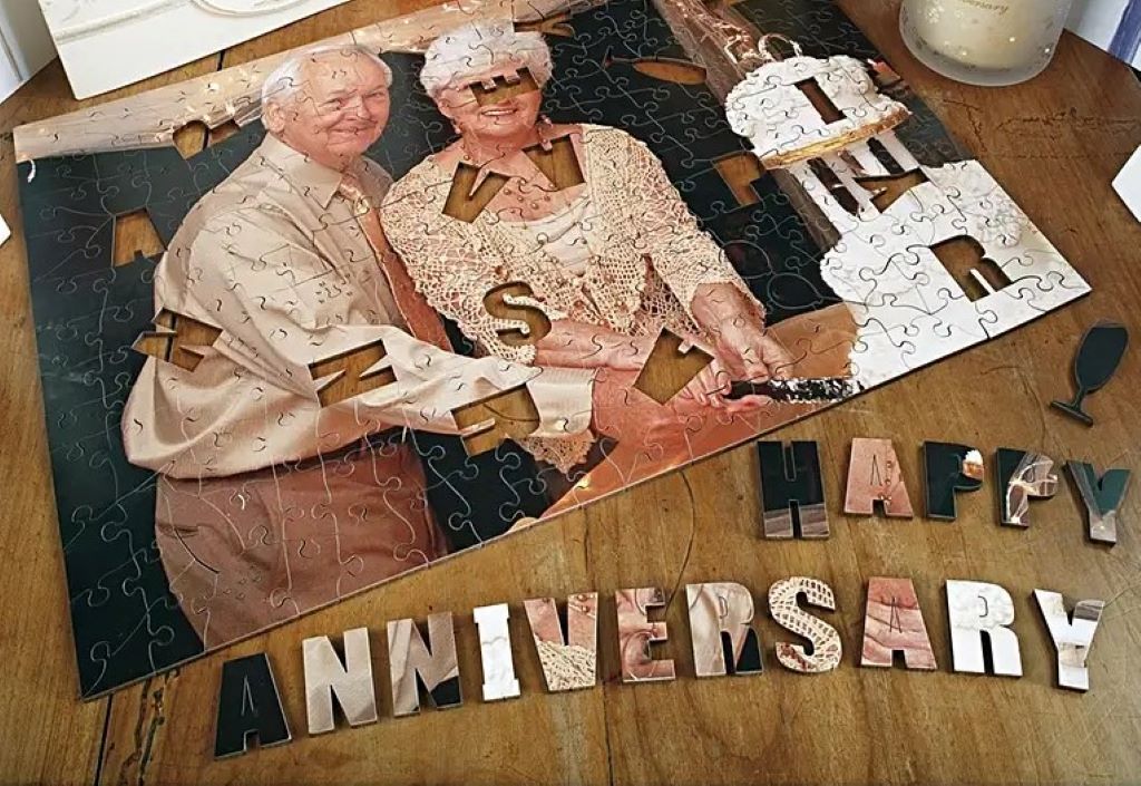 A personalized anniversary gift puzzle showing an elderly couple and a cake