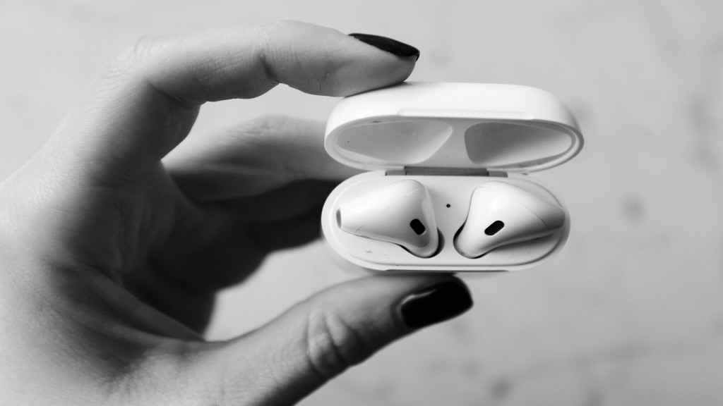 Hand holding an airPods case. Black and white photo