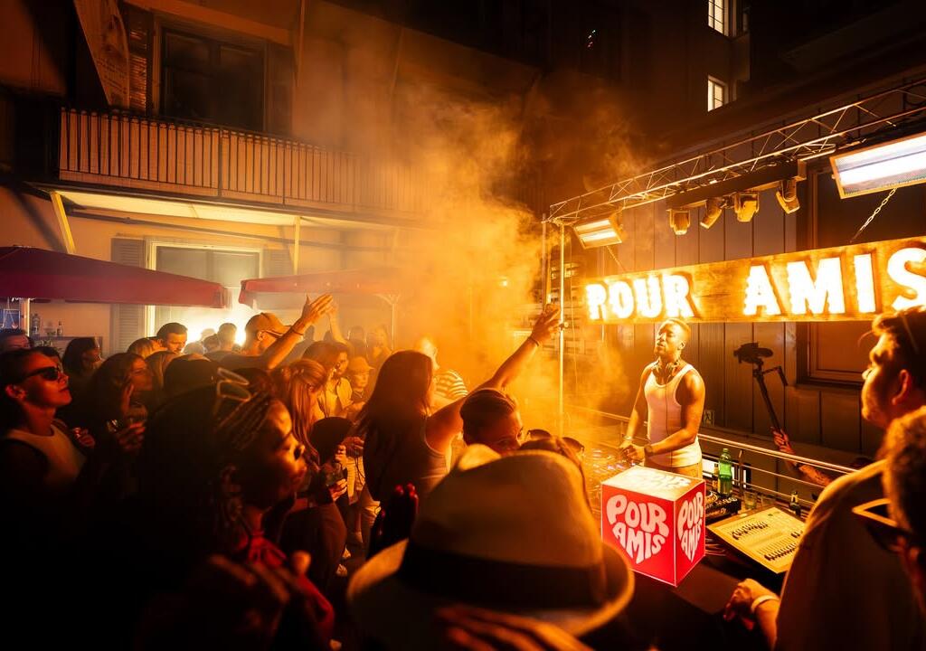 Illuminated Pour Amis cube light box at a packed DJ event